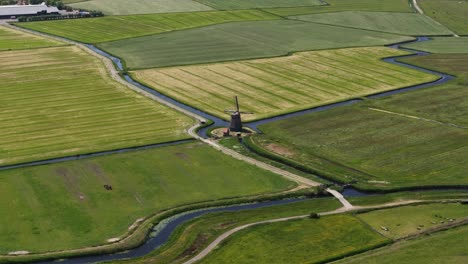 dutch windmill in green countryside. vintage cultural heritage building. aerial drone video.