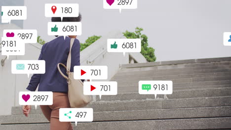 animación de iconos de las redes sociales contra la vista trasera de una mujer afroamericana subiendo las escaleras