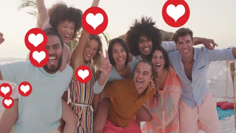 animation of social media heart icons over portrait of smiling friends on beach