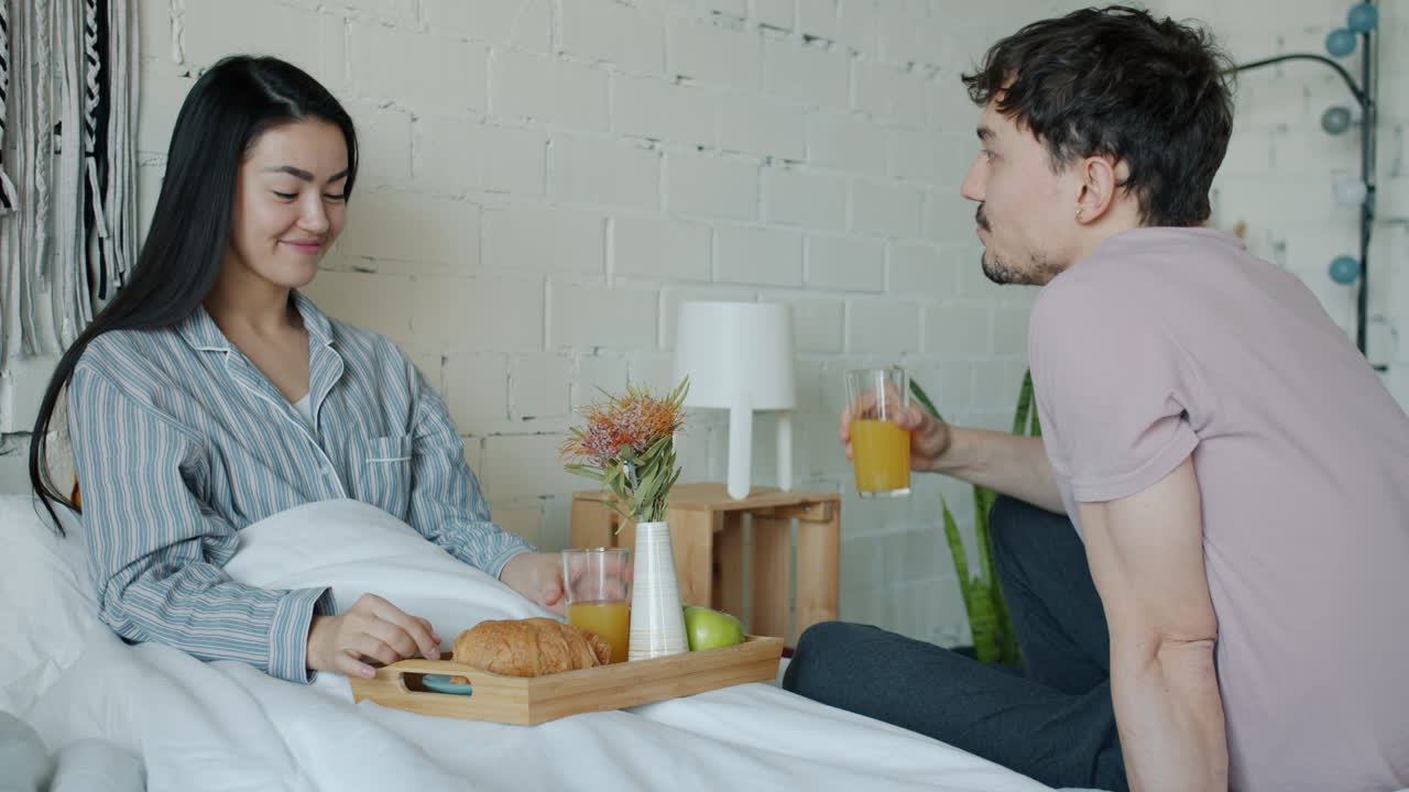 침대에서 아침 식사를 즐기는 커플