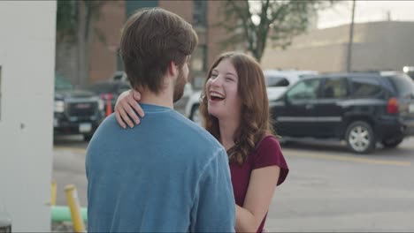 woman laughing while embracing with man