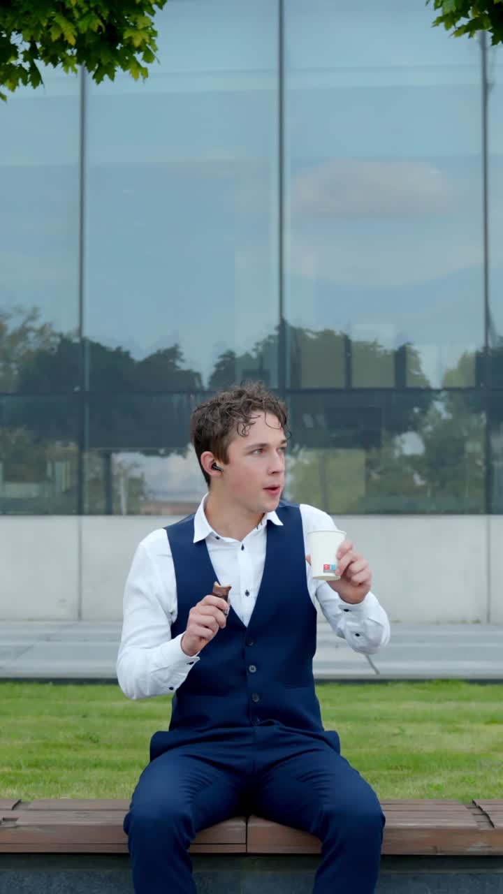The Young Finance Analyst Takes a Short Coffee Break While Staying Focused on His Work - Vertical Shot