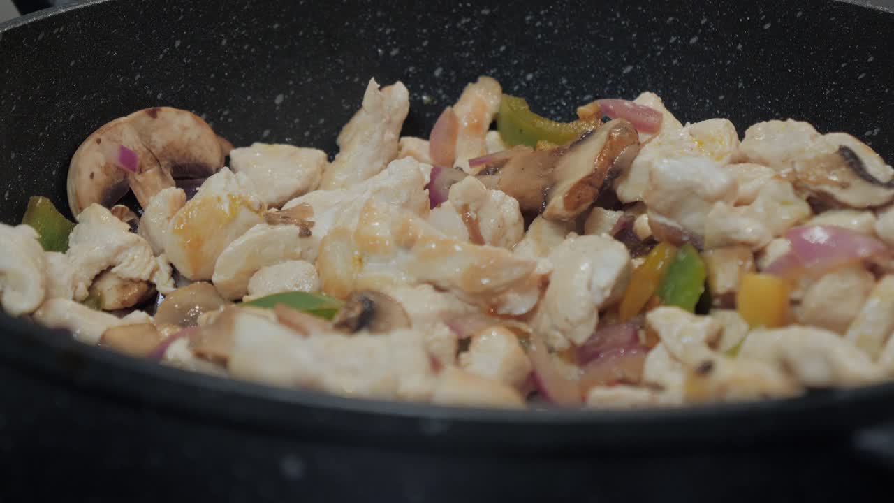 요리 팬에 있는 닭고기의 동작 제어 샷