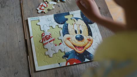 little girl with autistic disorder playing at home, closeup of puzzles