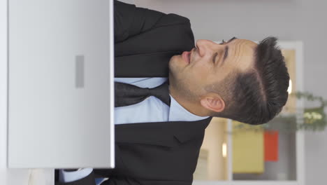 Vertical-video-of-Home-office-worker-man-working-relaxed-and-peacefully.