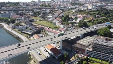 aerial view of a highway full of cars in a bridge above the river of porto