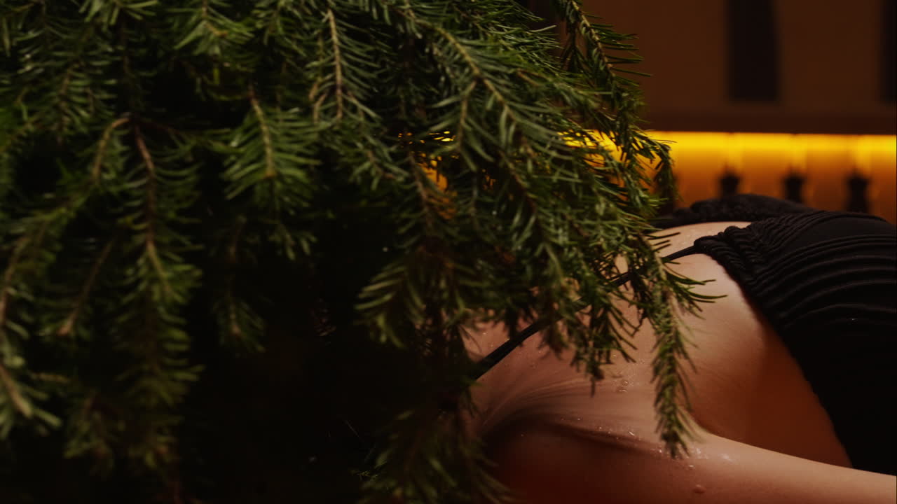 Woman receiving a spa treatment with fir