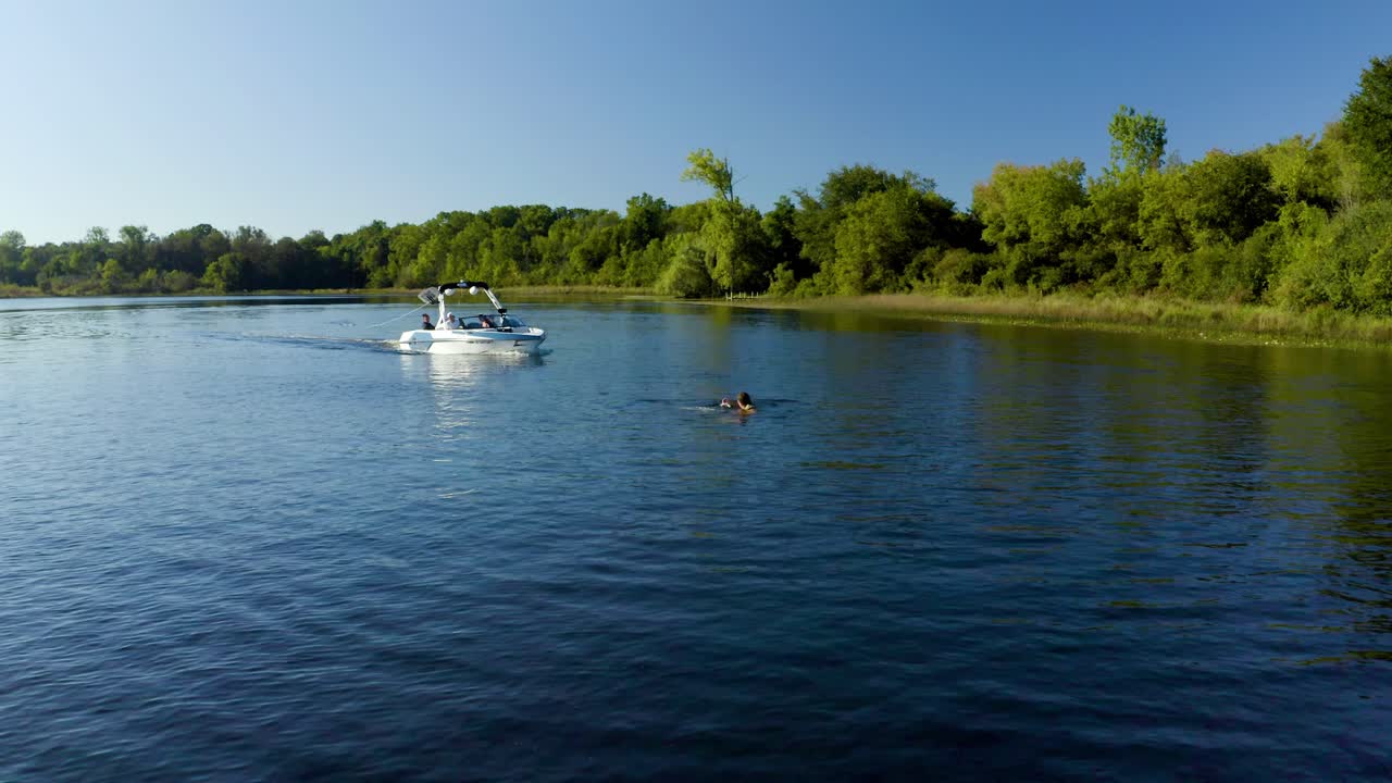 People Waterskiing and Swimming in a Lake