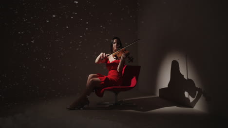 woman playing violin in red dress