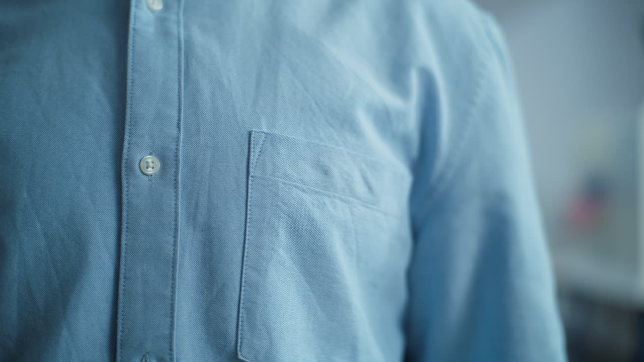 Businessman Puts on Badge with American Flag Logo and Inscription i Voted Close up of Anonymous Businessman or Man Putting on Badge with American Flag Logo and Inscription i Voted us Citizen at Polling Station during Elections National Election Day in the United States