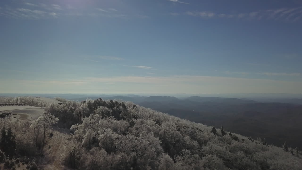 Ice coats trees along Blue Ridge Mountains as drone captures magnificent flyover of vista.