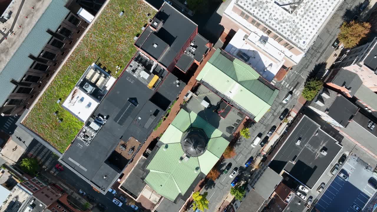 Traffic on Main Street in Lancaster downtown with green cupola of city hall building. Sunny day in American city. Aerial top down flyover. Pennsylvania, USA