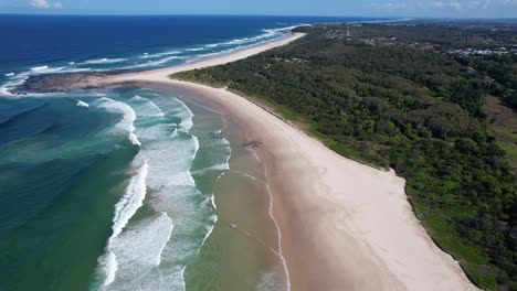 Sharpes-Beach-With-Blue-Ocean-Waves-Splashing-On-Sandy-Shore-In-New-South-Wales,-Australia---aerial-shot