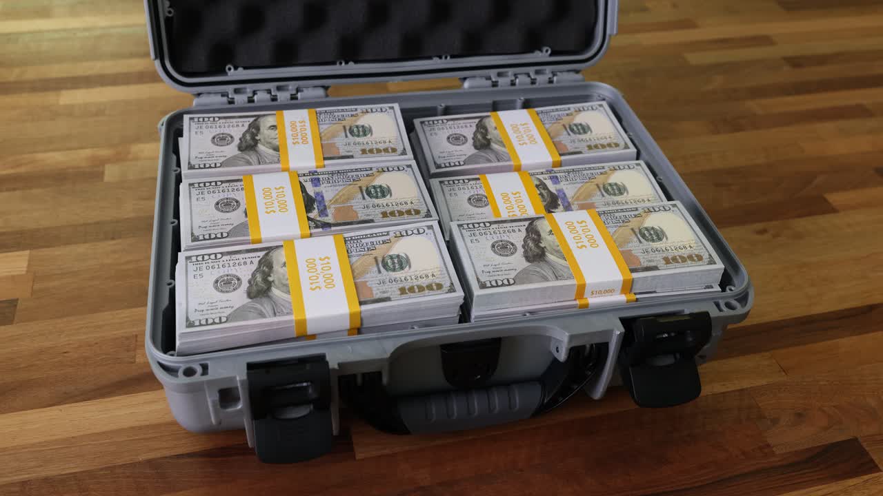 Briefcase filled with stacks of US hundred dollar bills