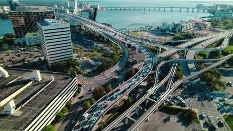 Sweeping-aerial-view-of-Jacksonville's-highway-interchange,-showcasing-complex-urban-transport-dynamics