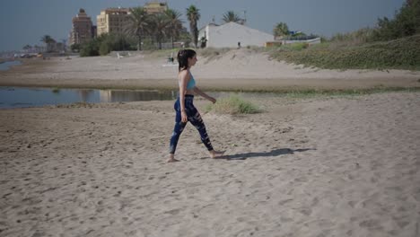woman walking on the beach and drinking