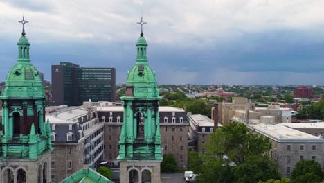 aerial view of a city church with two green towers