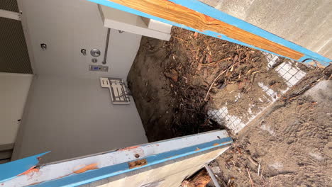 Vertical-video,-interior-of-a-public-bathroom-with-debris-after-a-storm-in-Capitola,-California