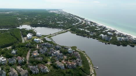 slow-spin-motion-wide-full-view-of-Cramp-Creek-Lake,-with-community-around-it-,-active-transit-and-ocean-in-the-background-right