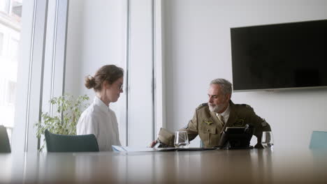 Young-woman-talking-with-military-man