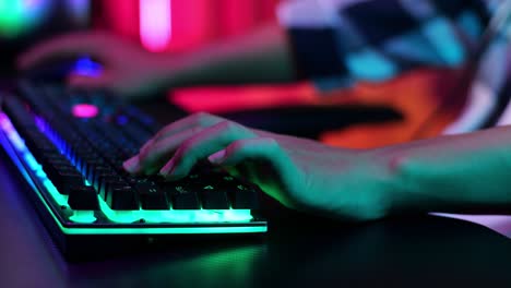 hands gamer boy using the keyboard while playing video game