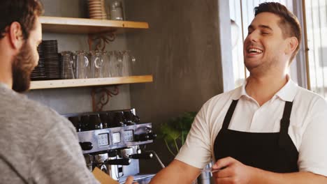 Waiter-and-customer-at-counter