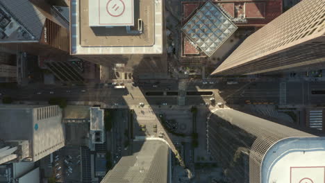 Downtown-Area-of-big-city-view-on-main-road-through-skyscrapers-with-little-car-traffic-due-to-Covid-19-Coronavirus-Pandemic-Lockdown-restrictions,-Aerial-Birds-Eye-Overhead-View