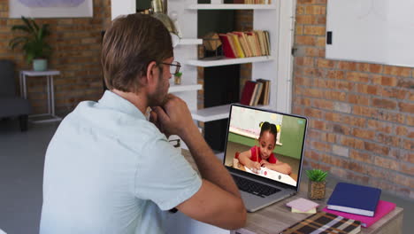 profesor caucásico usando una computadora portátil en una videollamada con una colegiala