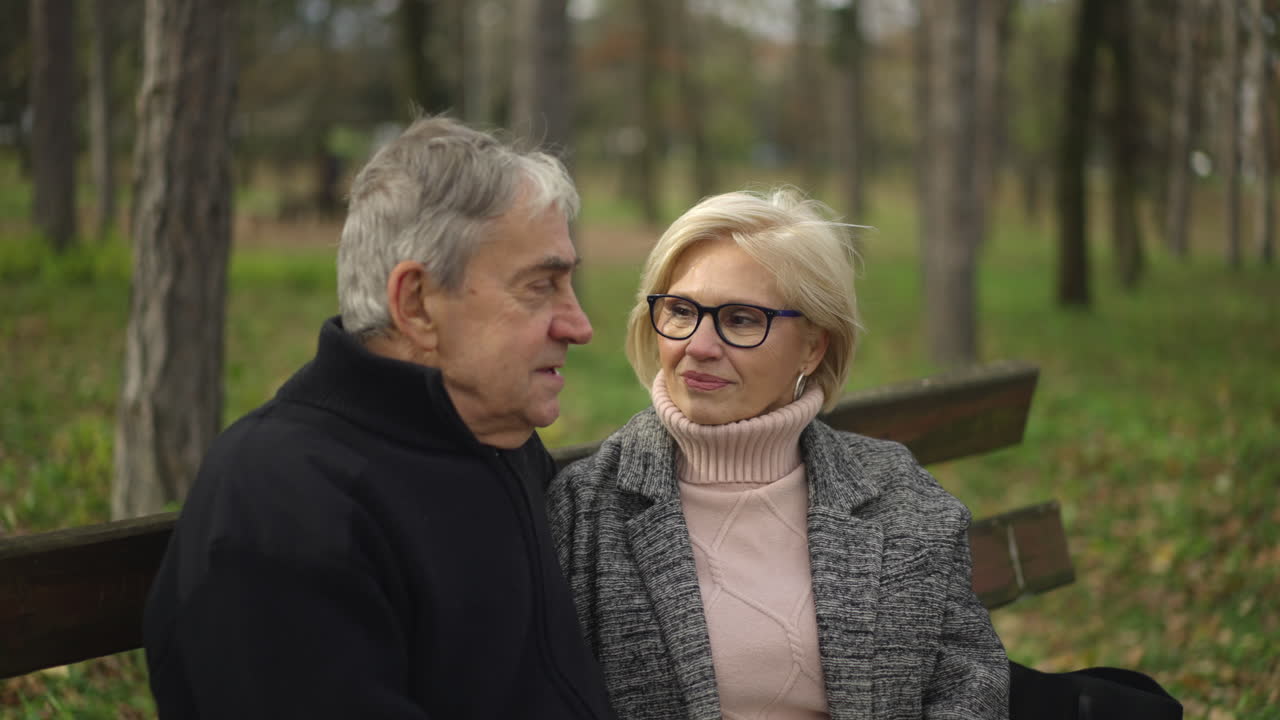 Elderly couple enjoying a day in the park during autumn