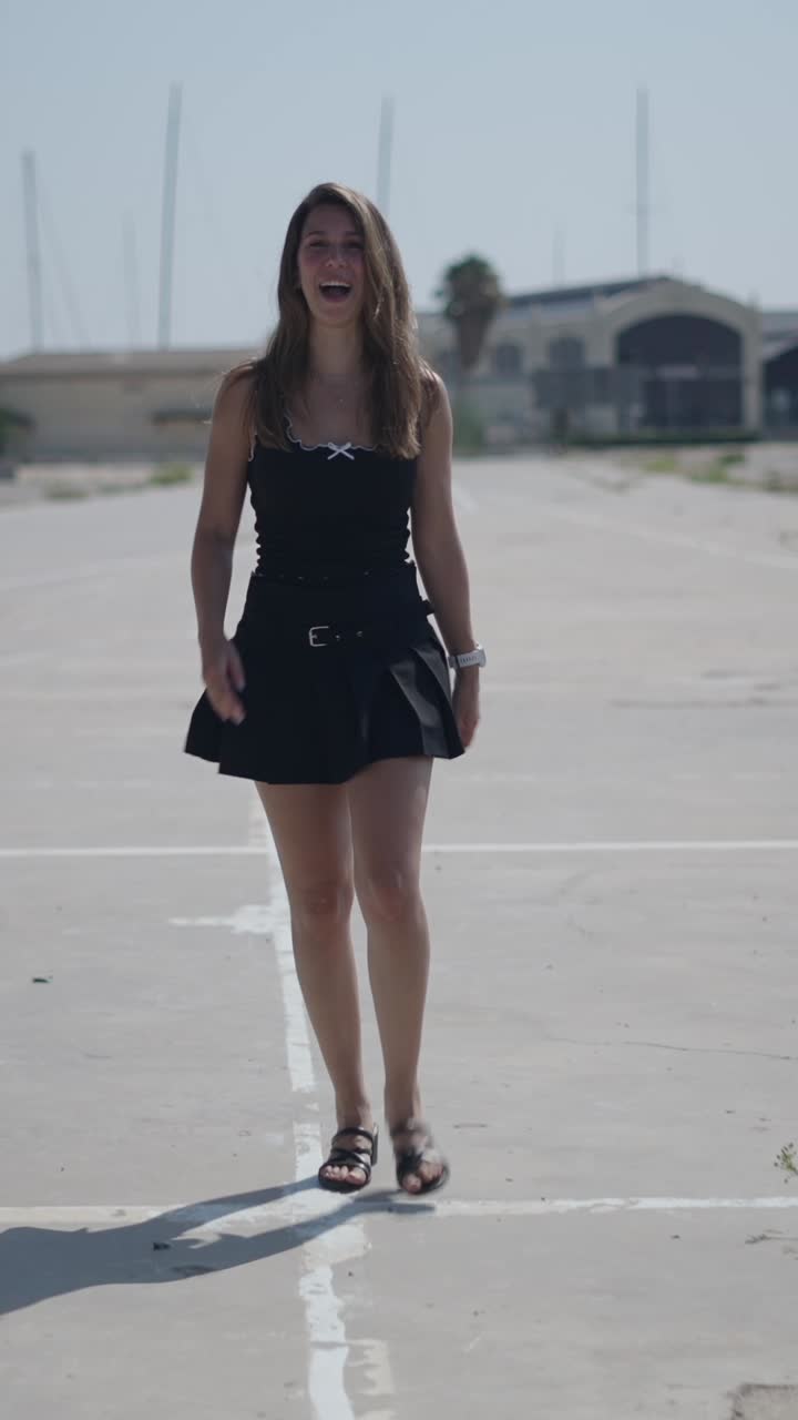Woman in black skirt and tank top walking
