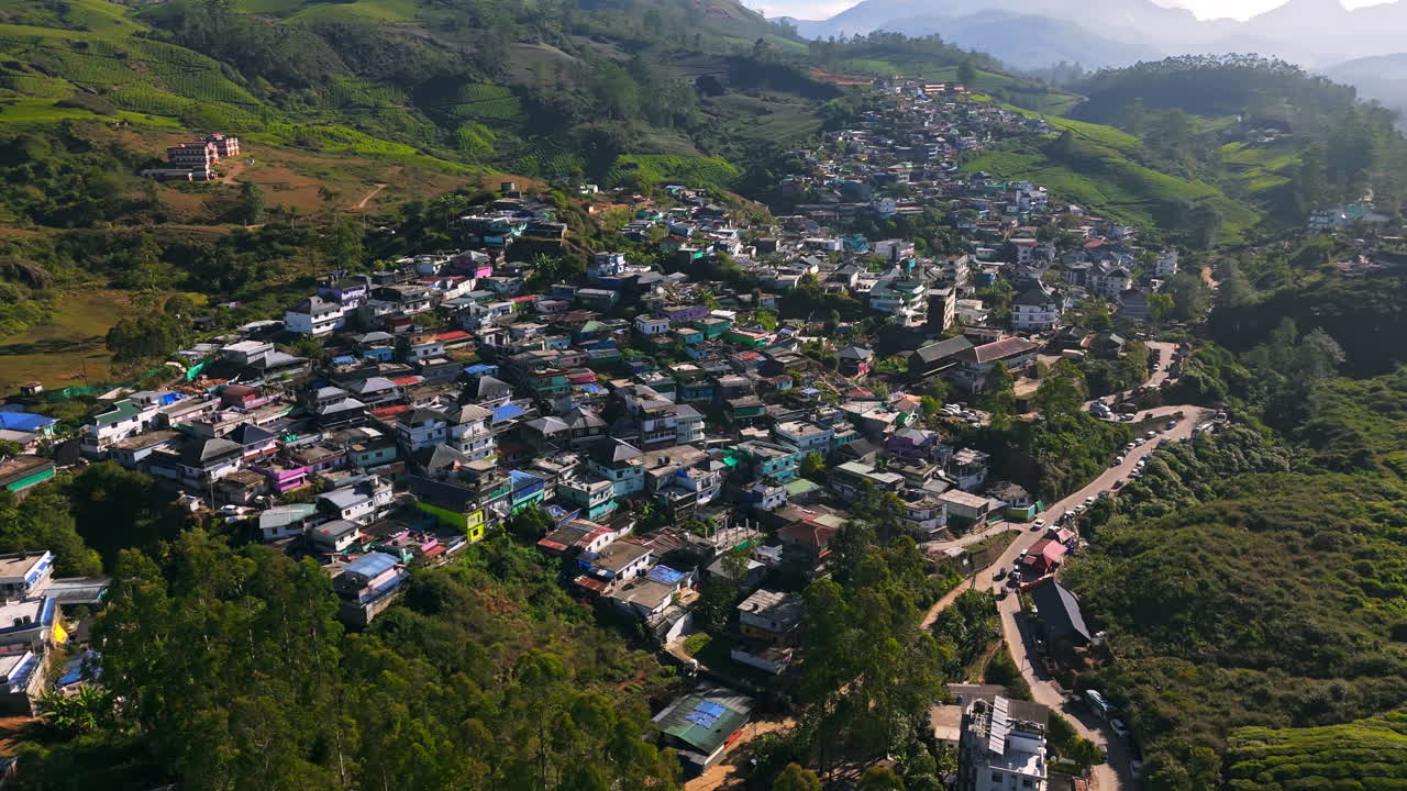 Aerial view circling homes in the Munnar hill station, sunny day in India
