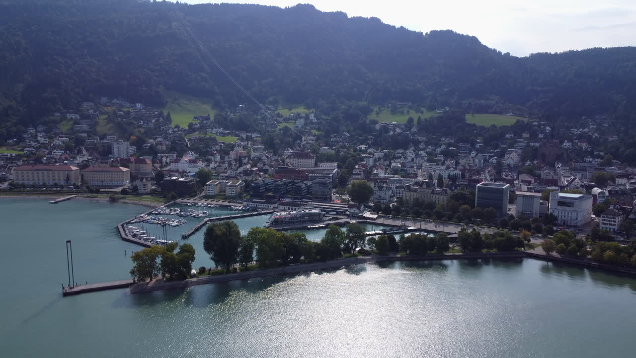 Aerial backwards revealing Bregenz on sunny day, Austria