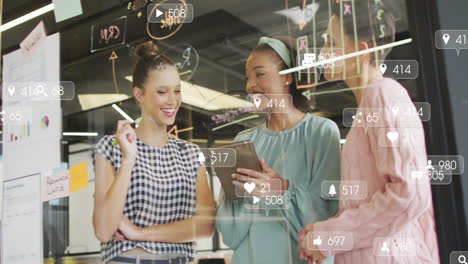 social media engagement animation over diverse women collaborating in modern office