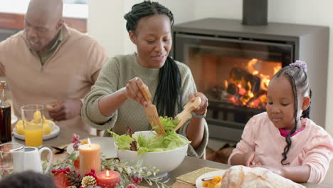 african american parents, children and grandparents celebrating at thanksgiving dinner, slow motion