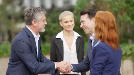 business professionals shaking hands outdoors
