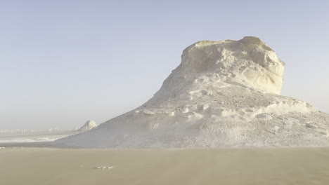 the egyptian white desert adventure tourism with bedouin camping and 4x4 driving through the desert to see rock formation and sand and dust at sunset and golden hour