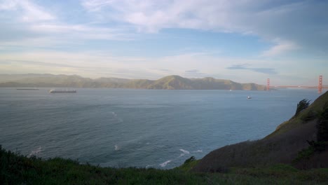 san francisco golden gate bridge and ship passing by