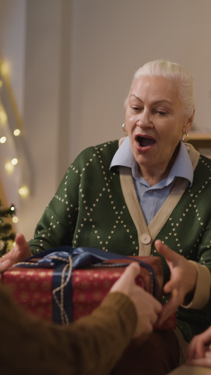 Senior Woman Receiving Gifts at Christmas