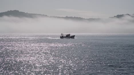 boat in tejo river  with fog in background