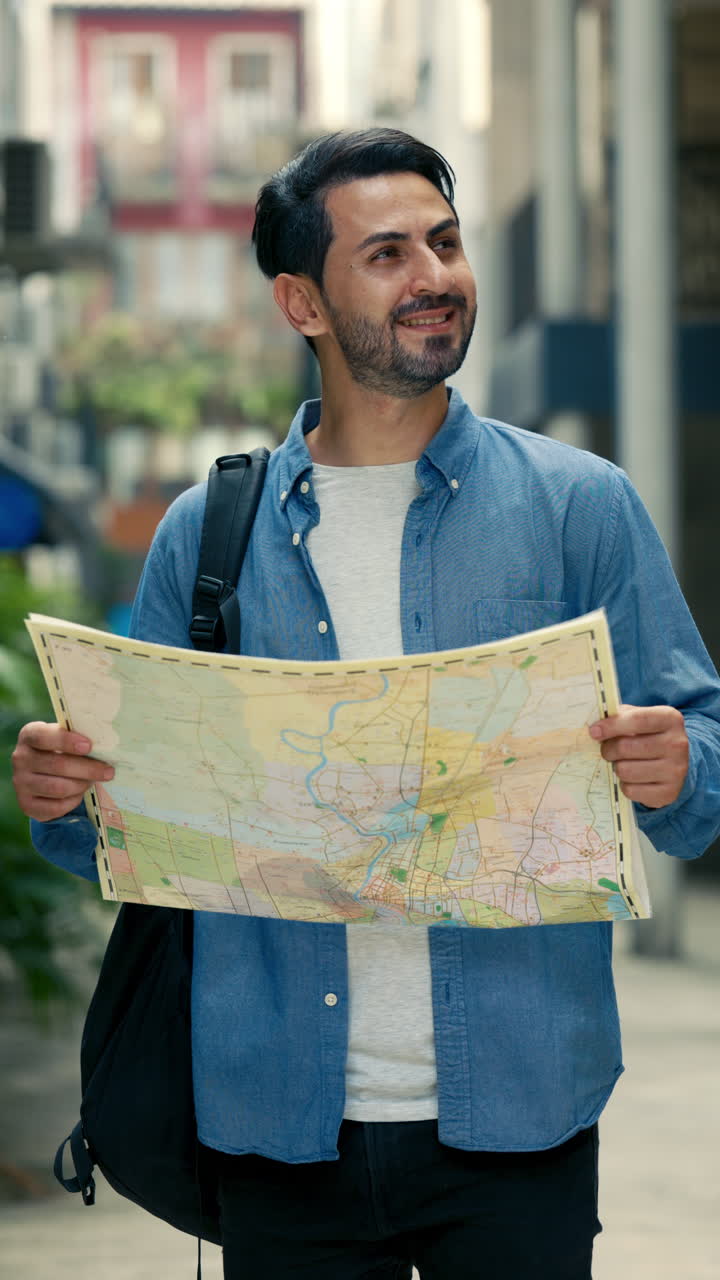 Happy Young Man Exploring City with a Map