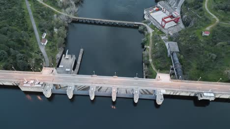 Drone footage of a dam at a reservoir in Cáceres, Extremadura. Showcasing water infrastructure surrounded by natural landscape