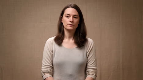 portrait of a woman with brown hair against a plain background
