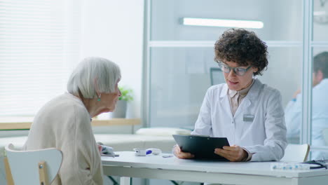 female doctor consulting elderly woman in clinic