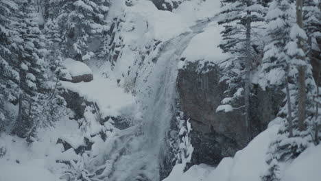 snowy waterfall in the mountains