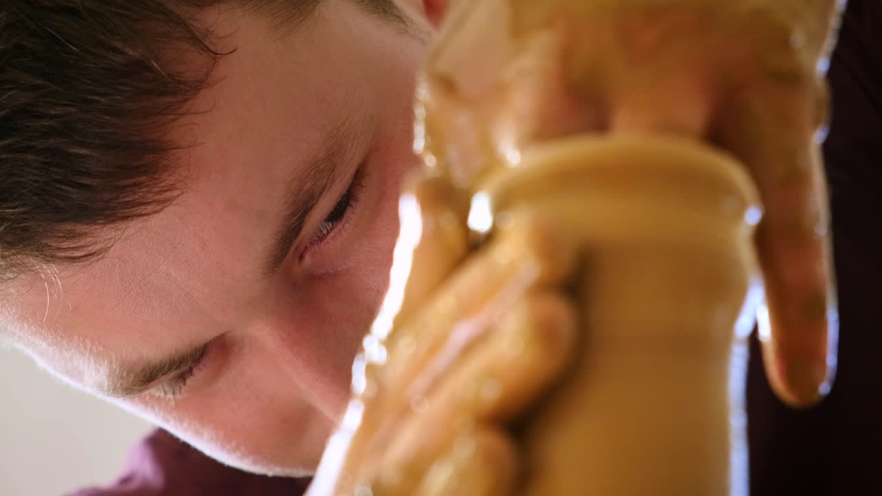 A Passionate Pottery Artist Shaping Clay with Precision and Skill: Creating Beautiful Ceramics Through the Art of Wheel Throwing and Hand Crafting