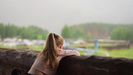 Little-girl-looks-at-helicopter-spending-time-on-terrace