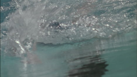 a woman swims through the water