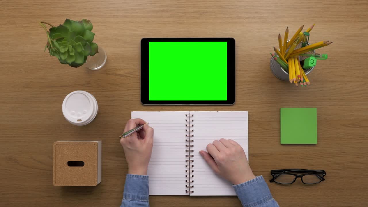 Overhead Top View Of woman Preparing To-Do List In Notebook