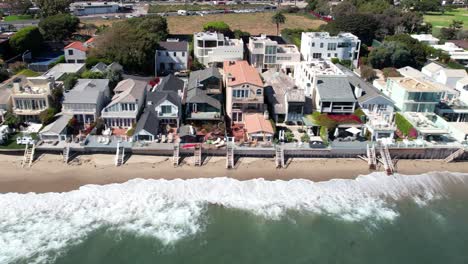 celebrity homes lines shoreline of sandy malibu beach, aerial view during the day