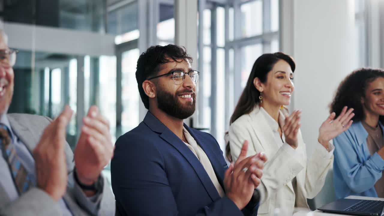 Happy team applauding after a successful presentation